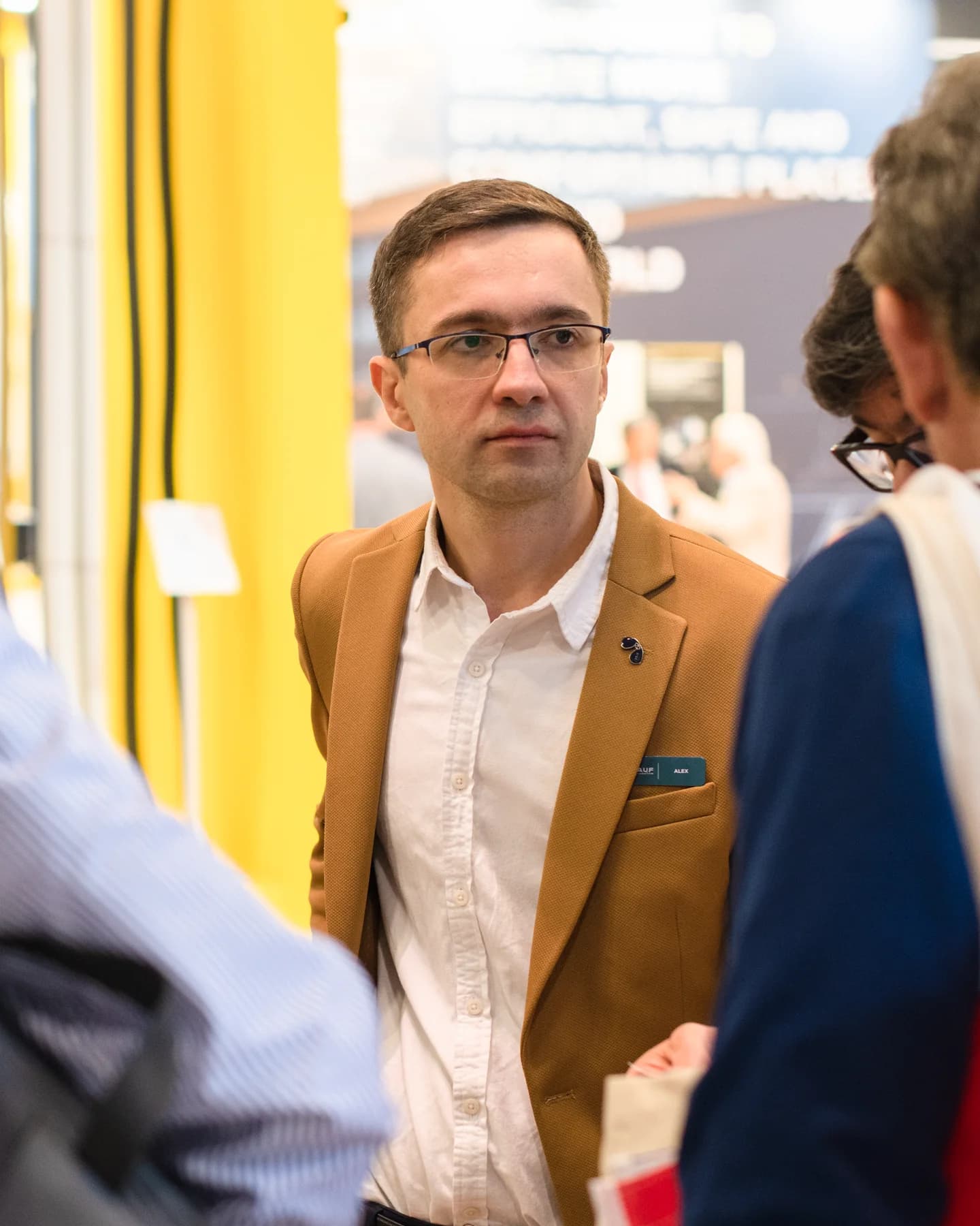 Alexey Skryabin speaking with visitors at an international HVAC exhibition